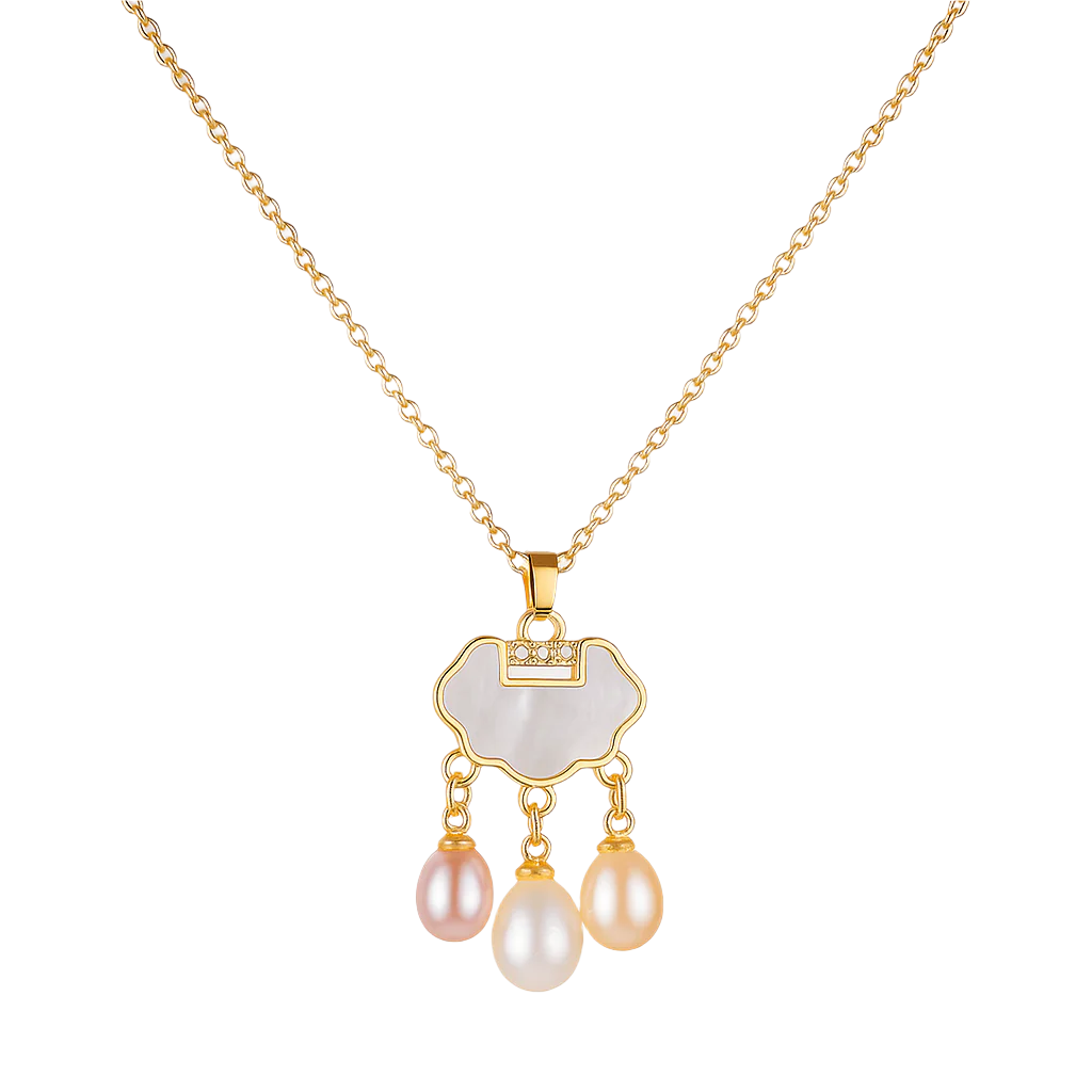 Gold necklace with a pendant featuring three pearls on a light background