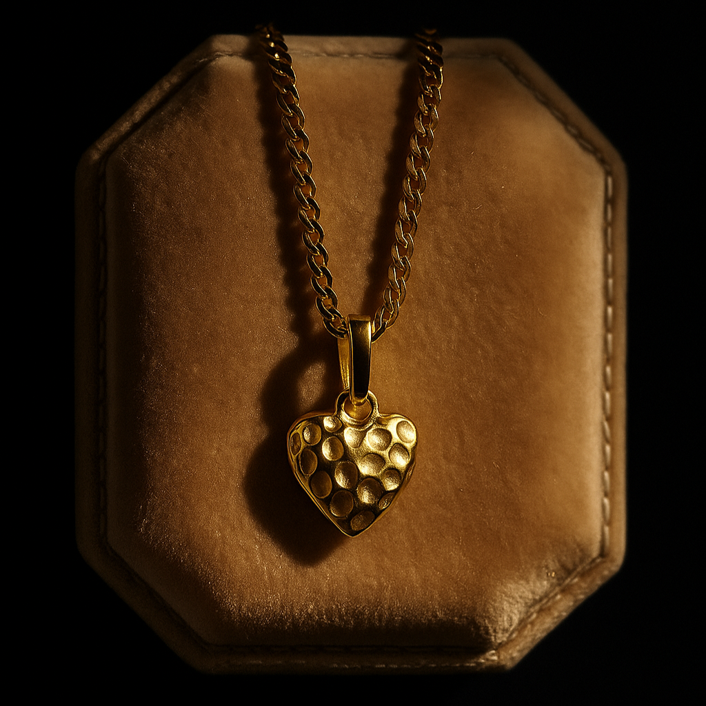 Gold heart-shaped pendant on a chain in a hexagonal brown leather case against a black background
