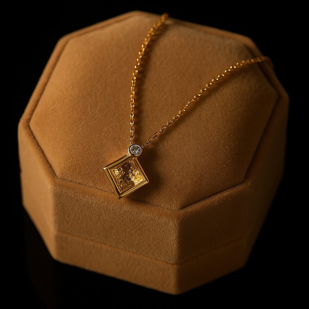 Gold necklace with a pendant on a brown jewelry box against a black background