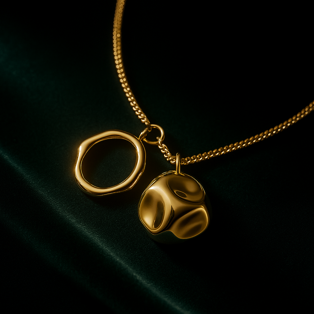 Gold necklace with two pendants on a dark background