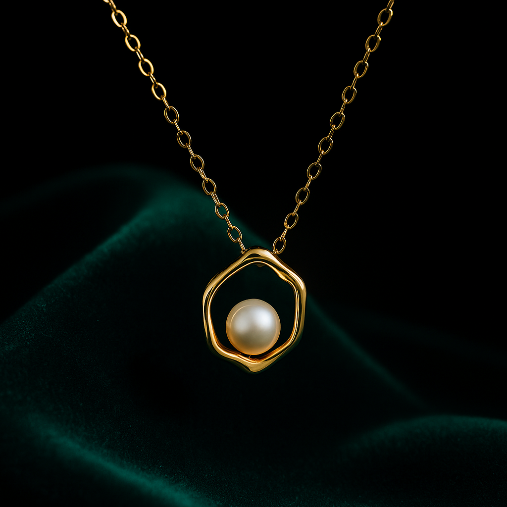 Gold necklace with a pearl pendant on a dark background