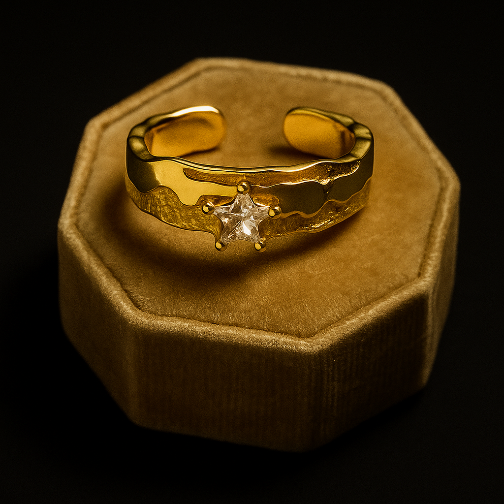 Gold ring with a diamond on a brown velvet cushion against a black background