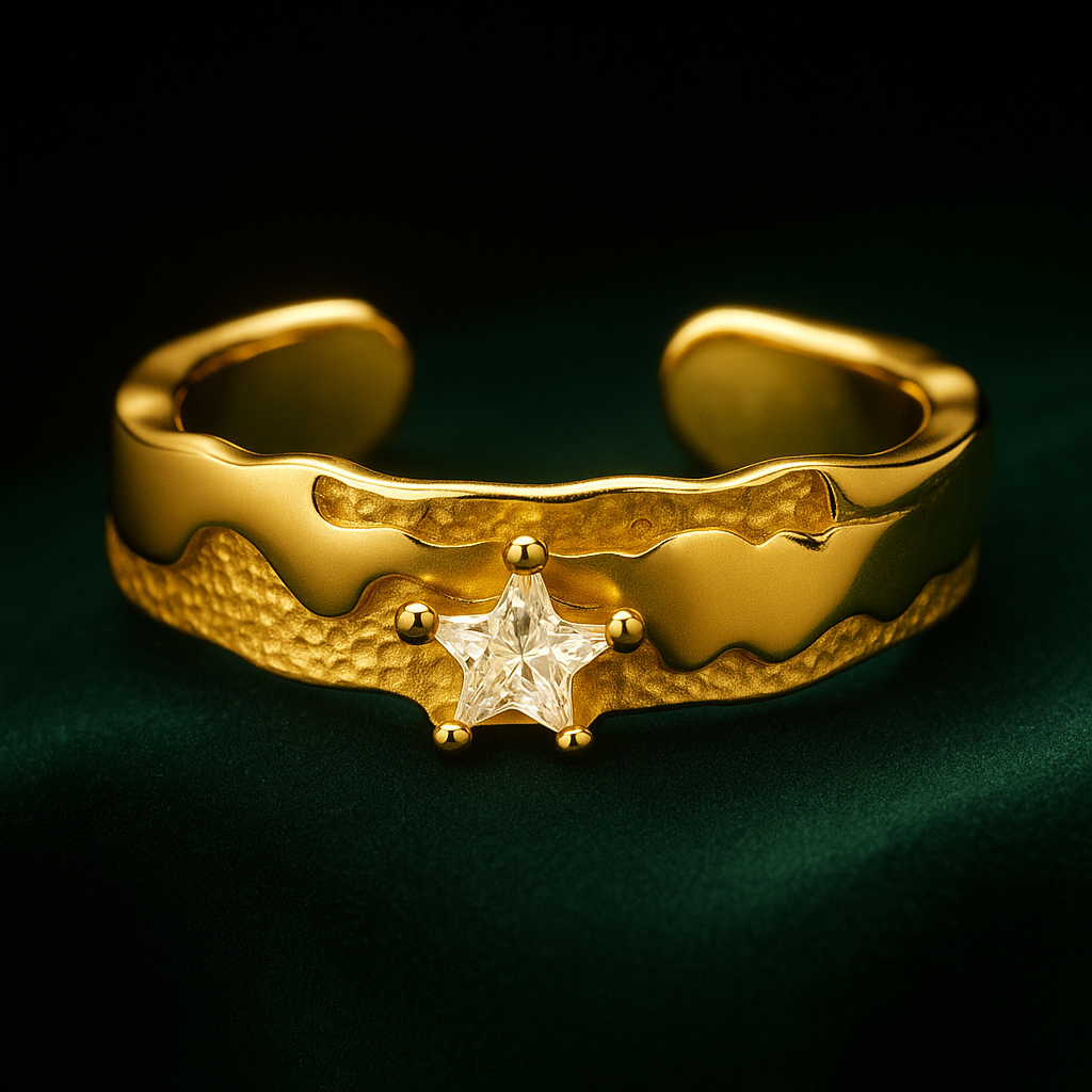 Gold ring with star design on a dark background