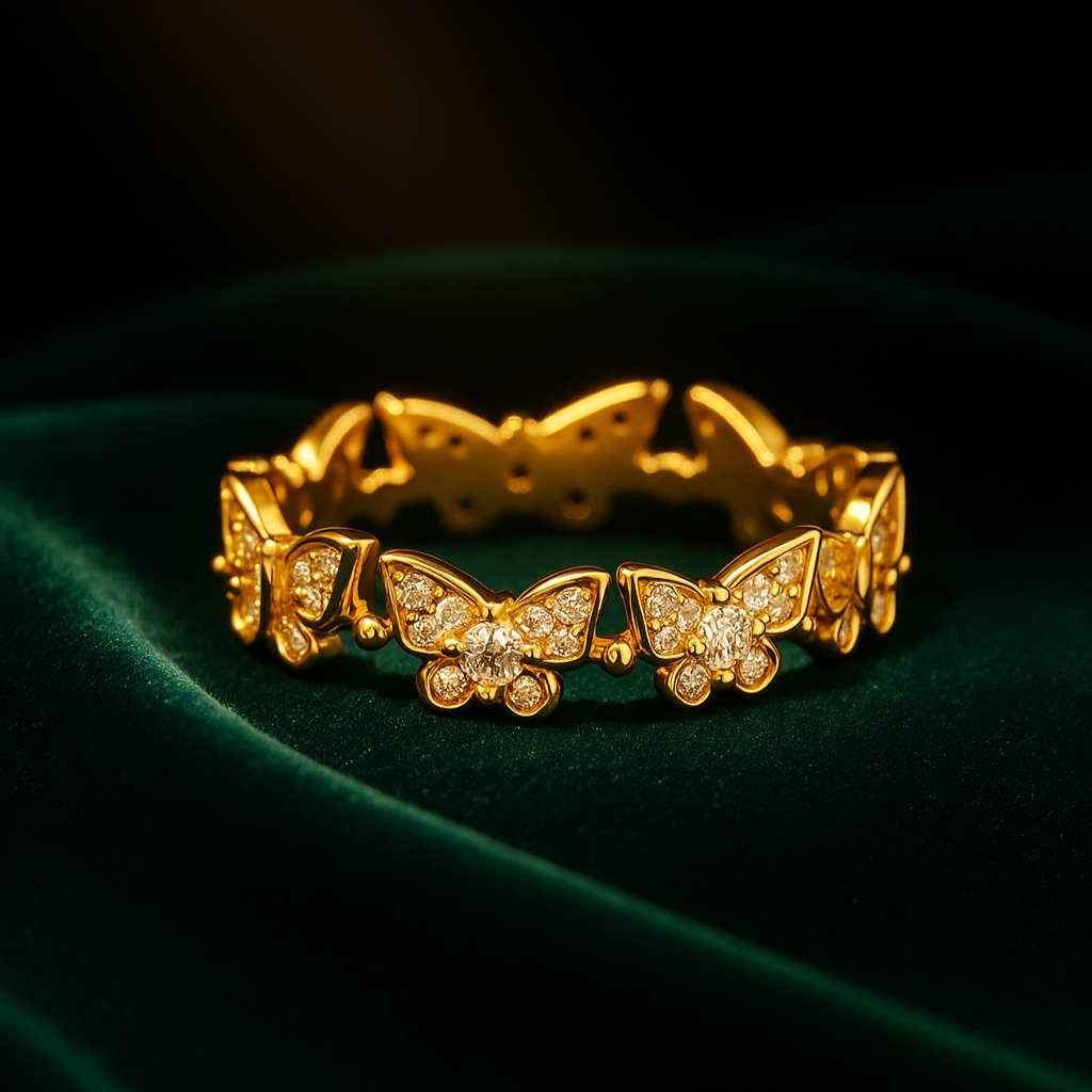 Gold bracelet with butterfly designs on a dark green fabric background
