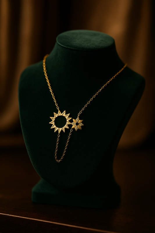 Gold necklace with sunflower pendant on a green velvet mannequin against a brown background