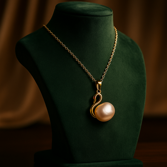 Gold necklace with a pearl pendant on a green velvet stand against a brown background