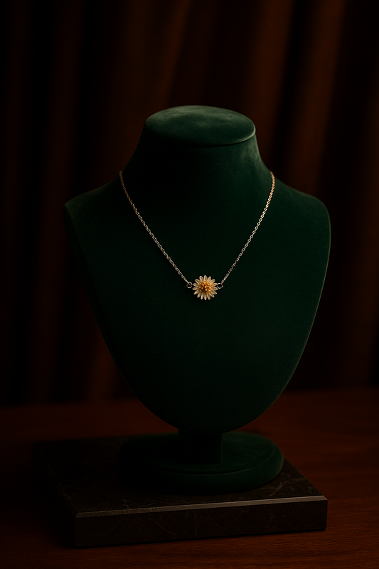 Necklace with a sunflower pendant on a green velvet mannequin against a dark background