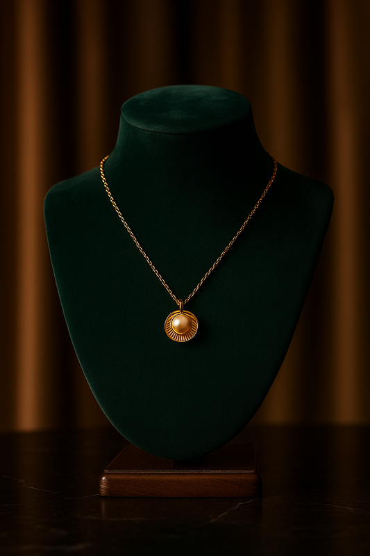 Gold necklace on a green velvet mannequin bust with a dark background