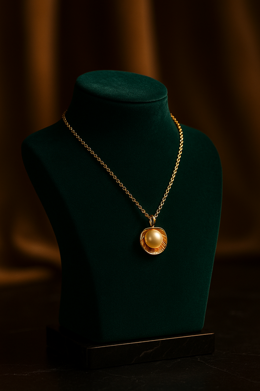 Gold necklace on a green mannequin bust against a dark background