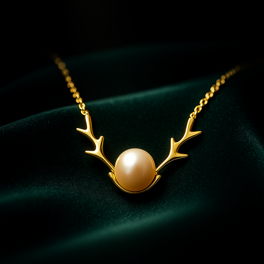 Gold necklace with a pearl pendant on a dark background