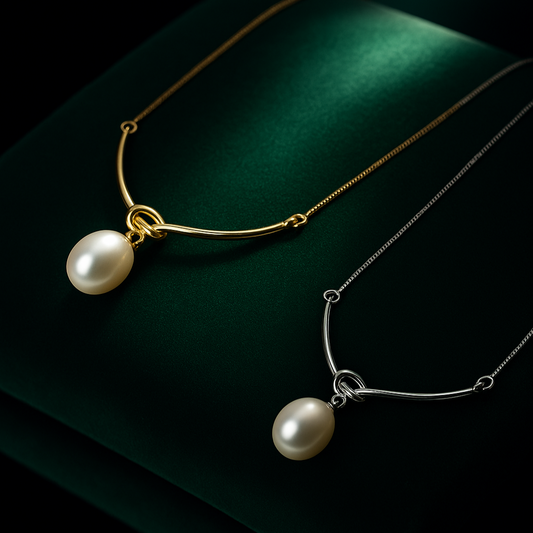Two pearl necklaces on a dark green fabric background