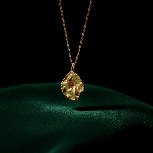 Gold necklace with a pendant on a dark background