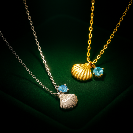 Two necklaces with shell pendants and blue gemstones on a dark background