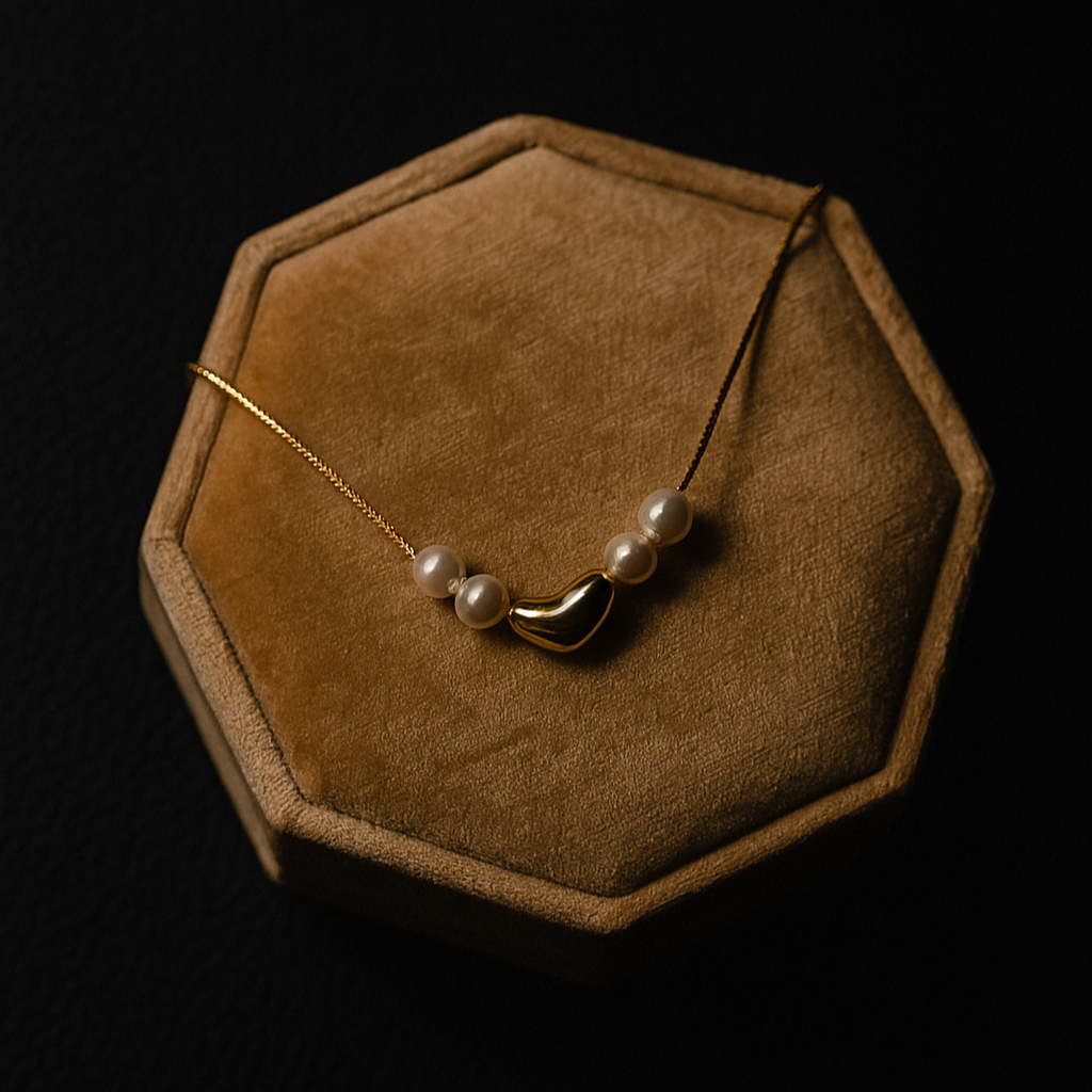 Necklace with pearls on a brown hexagonal velvet stand against a black background
