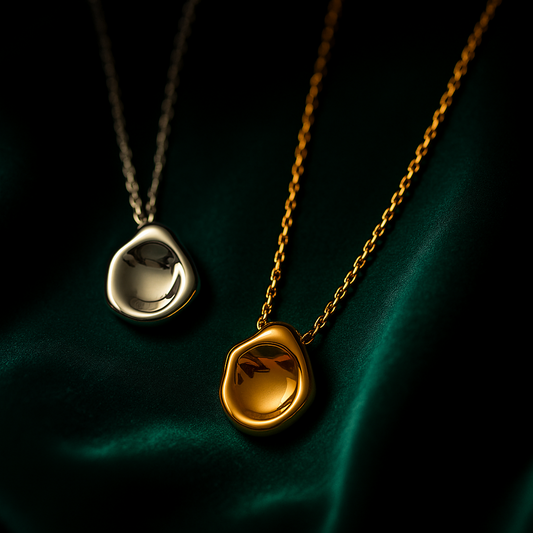 Two necklaces with pendant stones on a dark background