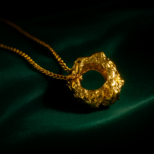 Gold necklace with a unique pendant on a dark background
