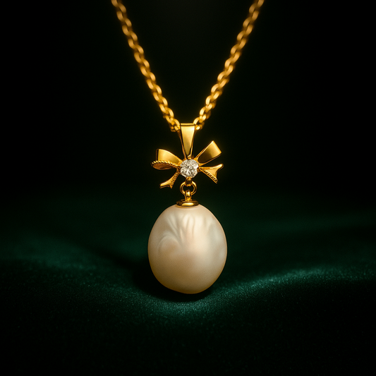 Gold necklace with a pearl pendant on a dark background