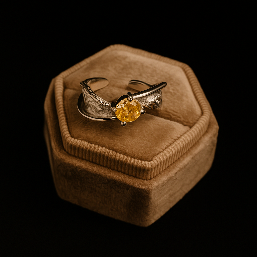 Gold ring with a yellow gemstone on a brown velvet cushion against a black background